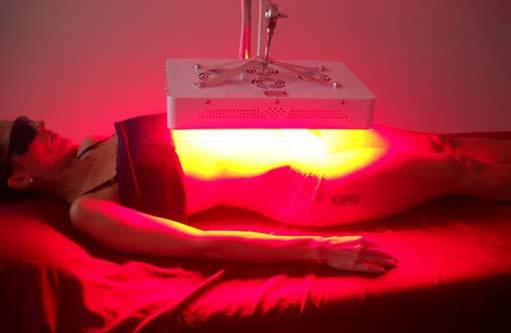 Woman being treated for obesity and weight loss using red light